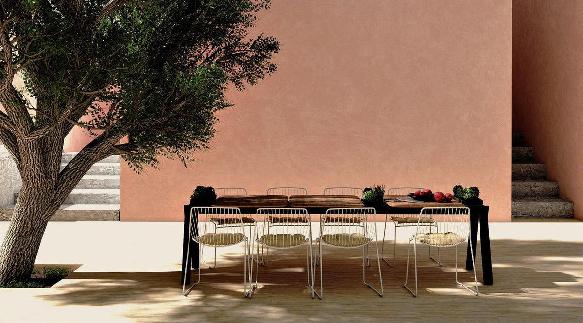 NUNC Ala outdoor table, on a terrace with wire chairs