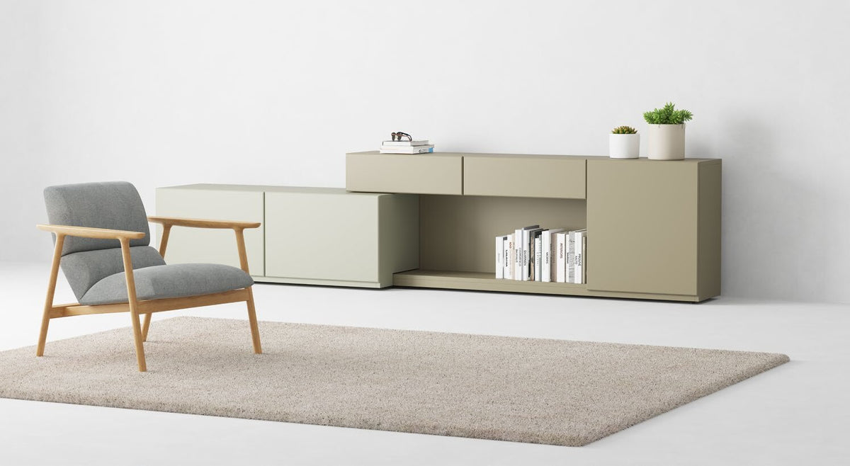 NUNC Dika lounge chair, oak and grey fabric in a living room setting