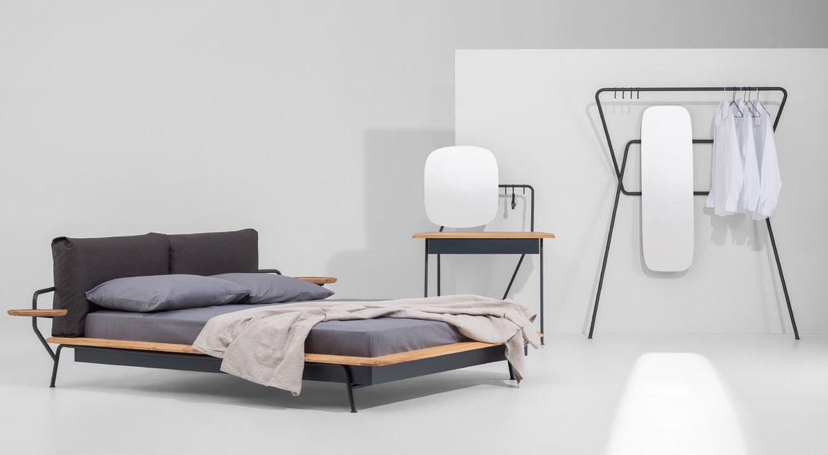 NUNC Kier bed, studio view with vanity table and clothes rack