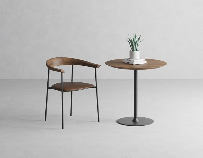 NUNC Nauvik dining chair, walnut backrest and leather seat beside a bistro table